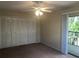 Bedroom featuring a ceiling fan, closet, and sliding glass doors leading to an outdoor balcony at 2597 Oak Park Way # 205, Orlando, FL 32822