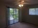 Bedroom featuring a ceiling fan, closet, and sliding glass doors leading to an outdoor balcony at 2597 Oak Park Way # 205, Orlando, FL 32822