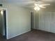Spacious bedroom featuring carpet floors, a ceiling fan, and a closet at 2597 Oak Park Way # 205, Orlando, FL 32822