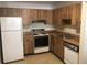 Charming kitchen with wood cabinets, white appliances, and laminate countertops at 2597 Oak Park Way # 205, Orlando, FL 32822