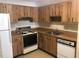 A charming kitchen showcasing wooden cabinets, laminate countertops, and essential appliances at 2597 Oak Park Way # 205, Orlando, FL 32822