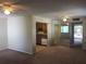 Open-concept living room showcasing ceiling fans, neutral paint, and view to kitchen and balcony at 2597 Oak Park Way # 205, Orlando, FL 32822