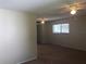 View of living room showing carpet, closet, ceiling fan, and light and bright window at 2597 Oak Park Way # 205, Orlando, FL 32822