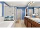 A bathroom features a soaking tub, a glass-enclosed shower, and double sinks at 2817 Noble Crow Dr, Kissimmee, FL 34744