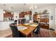 A dining area features a wooden table and chairs, with an adjacent kitchen boasting stainless steel appliances at 2817 Noble Crow Dr, Kissimmee, FL 34744