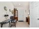 Inviting entryway featuring a tiled floor, front door, decorative accents, and a charming chair and display cabinet at 2817 Noble Crow Dr, Kissimmee, FL 34744