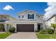 Beautiful two-story home featuring a two-car garage, brick driveway, and well-maintained landscaping at 2817 Noble Crow Dr, Kissimmee, FL 34744