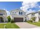 Charming two-story home with a two-car garage, brick driveway, and beautifully landscaped front yard at 2817 Noble Crow Dr, Kissimmee, FL 34744
