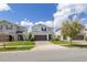 Charming two-story home boasts an attached two-car garage, manicured lawn and neutral-toned exterior at 2817 Noble Crow Dr, Kissimmee, FL 34744