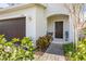 Charming front entrance with outdoor seating, beautiful plants, and an inviting doorway at 2817 Noble Crow Dr, Kissimmee, FL 34744