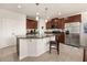 Spacious kitchen featuring a large island, stainless steel appliances, and rich brown cabinetry at 2817 Noble Crow Dr, Kissimmee, FL 34744