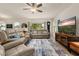 Spacious living room features comfortable seating, a large TV, and natural light from windows overlooking the backyard at 2817 Noble Crow Dr, Kissimmee, FL 34744