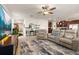 Open living room with reclining couches, a large TV, and a connected kitchen at 2817 Noble Crow Dr, Kissimmee, FL 34744