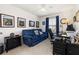 Comfortable home office with a blue sofa, desk, and views through a bright window at 2817 Noble Crow Dr, Kissimmee, FL 34744