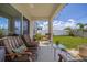 Inviting covered patio with cushioned chairs and a view of the manicured backyard at 2817 Noble Crow Dr, Kissimmee, FL 34744