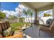 Inviting covered patio with cushioned chairs and a view of the manicured backyard at 2817 Noble Crow Dr, Kissimmee, FL 34744