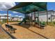 Community playground with slides, climbing structures, and a comfortable shaded bench at 2817 Noble Crow Dr, Kissimmee, FL 34744