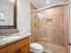 Bathroom featuring a glass enclosed shower, vanity with granite counters and tiled walls at 2900 E Grant Ave, Orlando, FL 32806