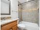 Bathroom features tiled shower-tub combination, granite countertop, and decorative mirror at 2900 E Grant Ave, Orlando, FL 32806