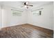 Spacious bedroom featuring wood-look flooring, white walls, and a ceiling fan at 2900 E Grant Ave, Orlando, FL 32806