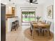 Eat-in kitchen features dining table and chairs next to sliding glass doors to a manicured lawn at 2900 E Grant Ave, Orlando, FL 32806