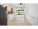 Open dining area with access to the backyard and a view of the kitchen at 2900 E Grant Ave, Orlando, FL 32806