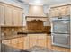 Modern kitchen featuring stainless steel appliances, sleek cabinetry, and granite countertops at 2900 E Grant Ave, Orlando, FL 32806