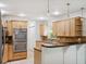 Well-equipped kitchen with wooden cabinets, stainless steel appliances, and granite countertops at 2900 E Grant Ave, Orlando, FL 32806