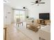Bright living room with neutral décor, ceiling fans, tile floors and large windows for natural light at 2900 E Grant Ave, Orlando, FL 32806