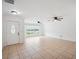 Spacious living room with tile floors, two ceiling fans, and a large window at 2900 E Grant Ave, Orlando, FL 32806
