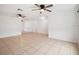 Spacious living area with tile flooring, ceiling fans and bright white walls throughout at 2900 E Grant Ave, Orlando, FL 32806