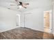 Cozy bedroom with wood floors, ceiling fan, closet and an en-suite bathroom at 2900 E Grant Ave, Orlando, FL 32806
