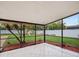 Screened patio overlooking landscaped backyard with white fence, play set, and mature trees at 2900 E Grant Ave, Orlando, FL 32806