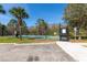 Gated community basketball court surrounded by mature trees and lush landscaping at 3006 Mandolin Dr, Kissimmee, FL 34744