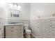 Small bathroom featuring decorative tile accent wall, white vanity, and classic toilet at 3006 Mandolin Dr, Kissimmee, FL 34744