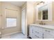 Bright bathroom with white vanity, large mirror, updated fixtures, and natural light at 3006 Mandolin Dr, Kissimmee, FL 34744