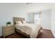 Bedroom with wood floors, a Queen bed, and a coordinated nightstand with a lamp at 3006 Mandolin Dr, Kissimmee, FL 34744