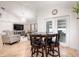 Cozy dining area features a round table, chandelier, and views into the living area and the backyard at 3006 Mandolin Dr, Kissimmee, FL 34744
