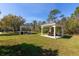Two gazebos sit on a grassy lawn in a common picnic area with green surroundings at 3006 Mandolin Dr, Kissimmee, FL 34744