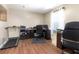 Home office featuring a treadmill, desk, rolling chairs, dark cabinets, and natural light at 3006 Mandolin Dr, Kissimmee, FL 34744