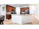Modern kitchen featuring dark cabinets, a granite countertop island, and stainless steel appliances at 3006 Mandolin Dr, Kissimmee, FL 34744