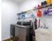 Functional laundry room with modern washer, dryer, utility sink, and wire shelving at 3006 Mandolin Dr, Kissimmee, FL 34744