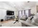 Comfortable living room with a large TV, neutral decor, and a chandelier at 3006 Mandolin Dr, Kissimmee, FL 34744