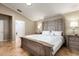 Calm main bedroom with a decorative bedframe, neutral decor, and an ensuite bathroom at 3006 Mandolin Dr, Kissimmee, FL 34744