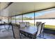 Relaxing screened patio with dining table, chairs, hammock, and tile flooring at 3006 Mandolin Dr, Kissimmee, FL 34744