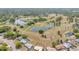 An aerial view of the community including a golf course, lush greenery and several lakes at 344 Sandpiper Dr, Casselberry, FL 32707