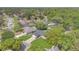 Aerial view of the property showcasing a green lawn and pool with surrounding mature trees at 344 Sandpiper Dr, Casselberry, FL 32707