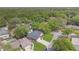 An aerial view of the home showcasing its landscaping, pool and proximity to lush trees at 344 Sandpiper Dr, Casselberry, FL 32707