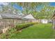 Green backyard featuring a garden, a fire pit, a bird feeder, a shed, and a wooden fence at 344 Sandpiper Dr, Casselberry, FL 32707