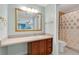 Bathroom with a vanity, decorative mirror, and tile floor, and a shower with a patterned curtain at 344 Sandpiper Dr, Casselberry, FL 32707